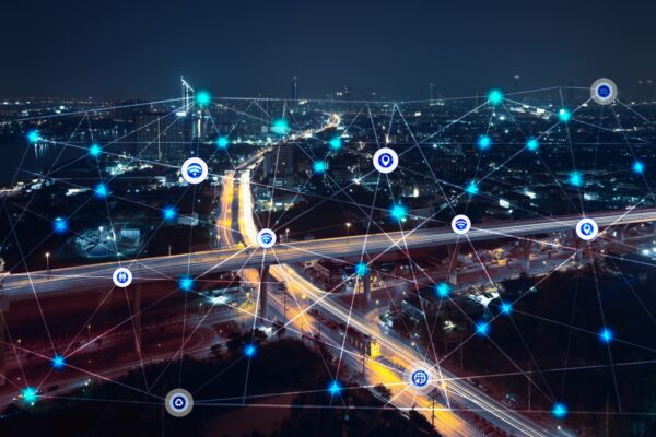 city at night with communication icons and network lines mix media concept background